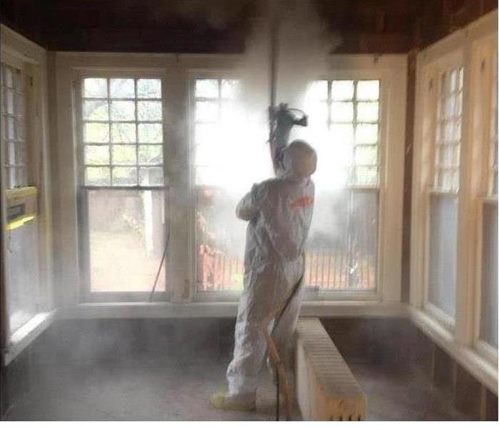A SERVPRO employee dry ice blasting inside a house.